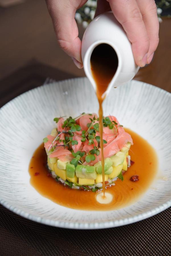 Royal Tulip Hotel & Casino, Тбилиси Экстерьер фото Soy sauce being drizzled over a sushi dish