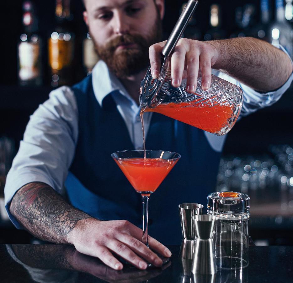 Royal Tulip Hotel & Casino, Тбилиси Экстерьер фото A bartender preparing a cocktail